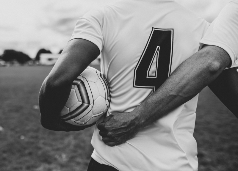 grass, jersey, sport, football field, close-up, hand, focus on foreground, 4K, blurred background, friends, players, football players, human body part