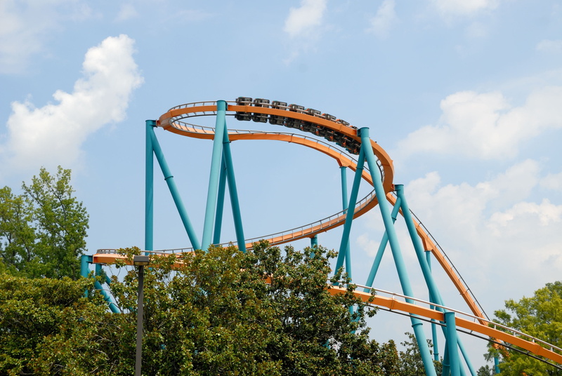 low angle view, day, architecture, amusement Park Ride, nature, tall - high, green color, structure, tree, high, joy, traveling Carnival, coaster, cloud - sky