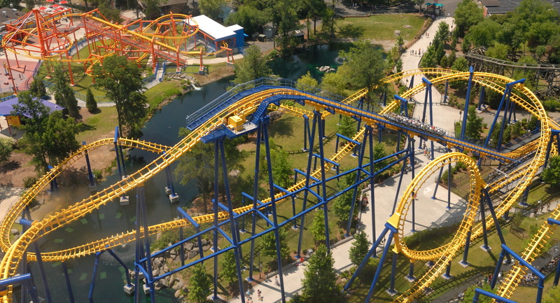 fun, connection, park, plant, ride, train - vehicle, high angle view, tree, rail, architecture, city, outdoors, train, Roller Coaster, attraction, entertainment