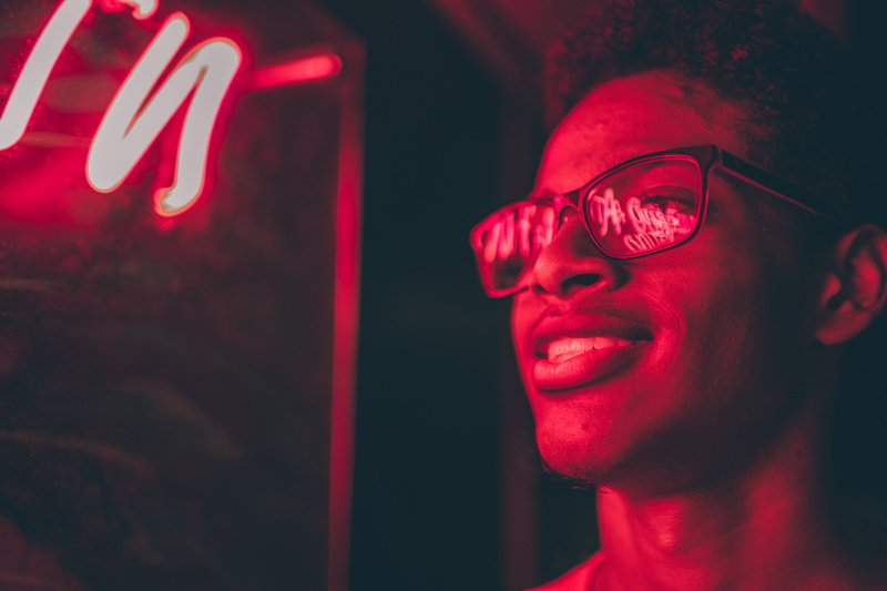 human face, red, person, headshot, man, eyeglasses, wearing, one person, reflection, adult, young adult, black, 5K, happiness, nightlife, indoors, neon