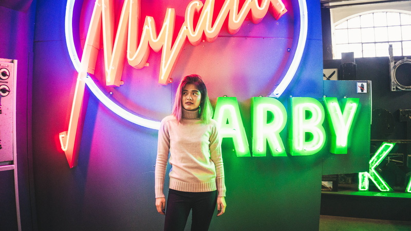 illuminated, positive emotion, museum, adult, communication, neon, one person, happiness, real people, standing, colours, colors, color, young adult, smiling