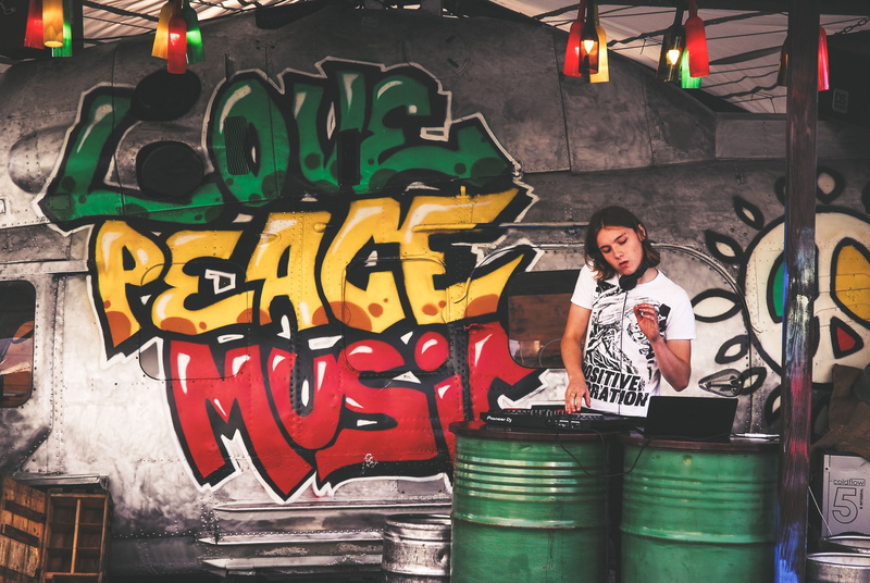 technology, people, dj, woman, 4K, turntable, real people, creativity, occupation, playing, multi colored, mural, one person, outdoors, cdj, lifestyles