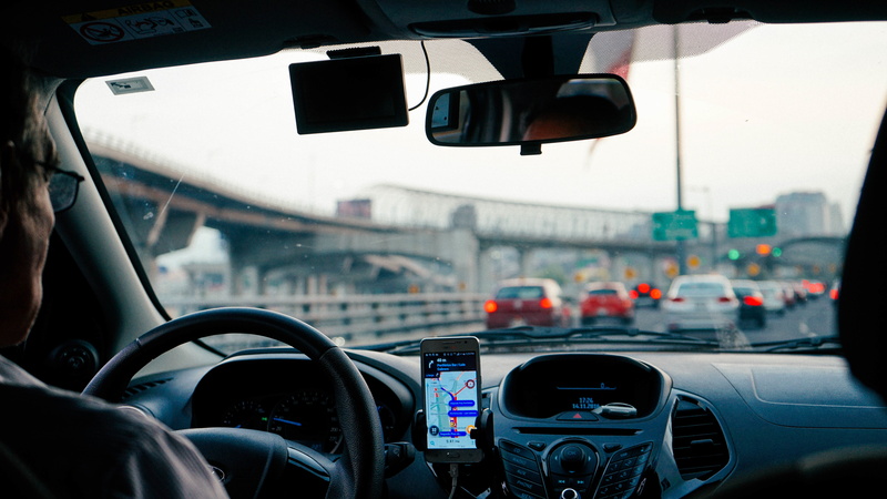 man, riding, no people, glass - material, vehicle, motor vehicle, stop light, wheel, radio, city, building, windshield, outdoor, car, travel, driving, lights