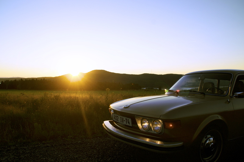 field, dusk, mode of Transport, lights, emblem, classic car, land Vehicle, mode of transportation, plains, chrome, car, land, outdoors, mountain, landscape