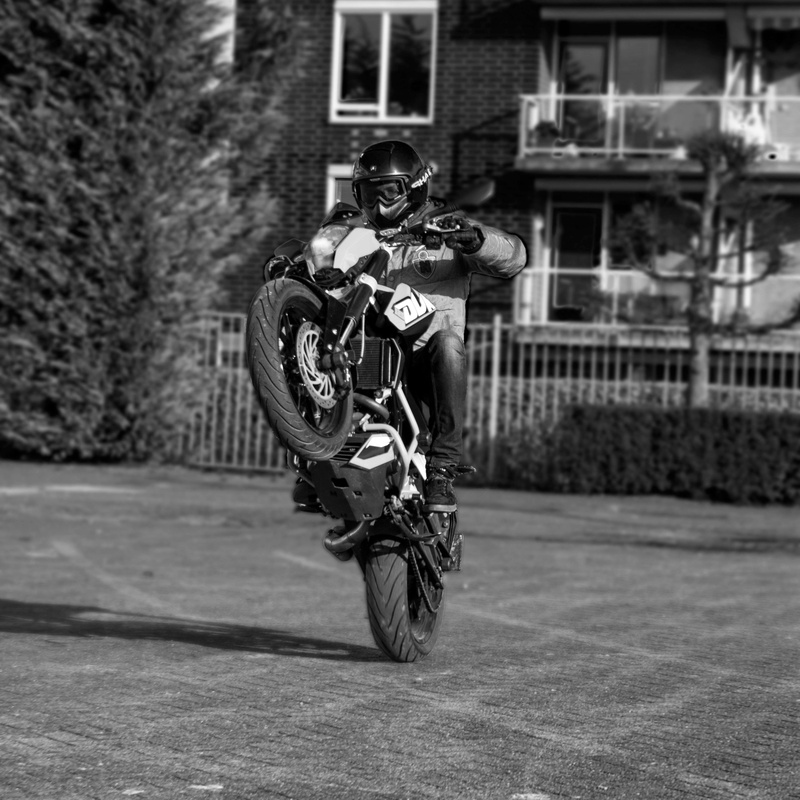 125cc, headwear, netherlands, bicycle, mode of transportation, road, safe, one weel, men, land vehicle, built structure, wheelie, real people, motorcycle