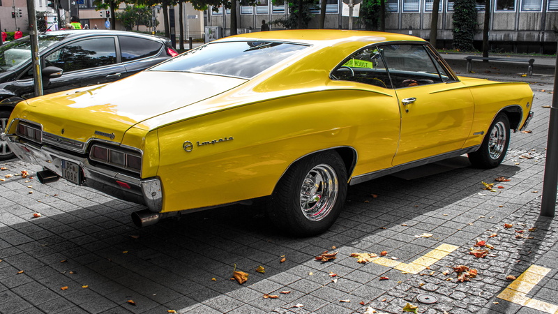 Chevrolet Impala, no people, city street, paving stone, city, road, 5K, architecture, motor vehicle, yellow taxi, car, mode of transportation, day, land vehicle