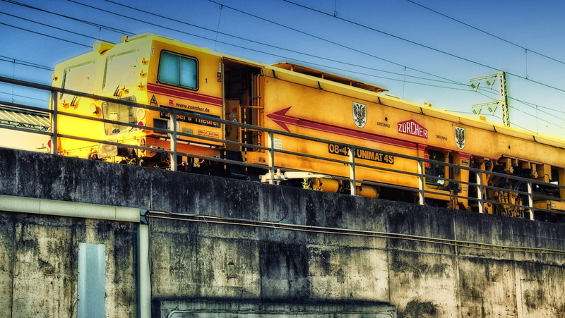 rail transportation, school bus, architecture, public transportation, low angle view, day, sky, track, built structure, building exterior, 720P, outdoors