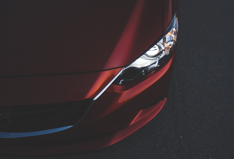 motor vehicle, day, headlamp, no people, headlight, retro styled, vehicle light, luxury, stationary, mode of transportation, city, shiny, 2K, mazda, black color