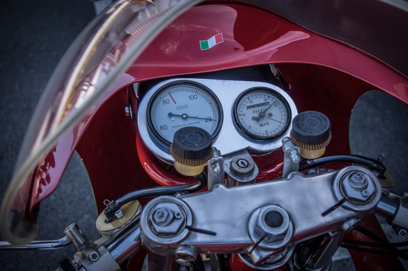 motorcycle, indoors, land vehicle, mode of transportation, metal, two wheeled vehicle, motor vehicle, speed display, close-up, gauge, dashboard, classic