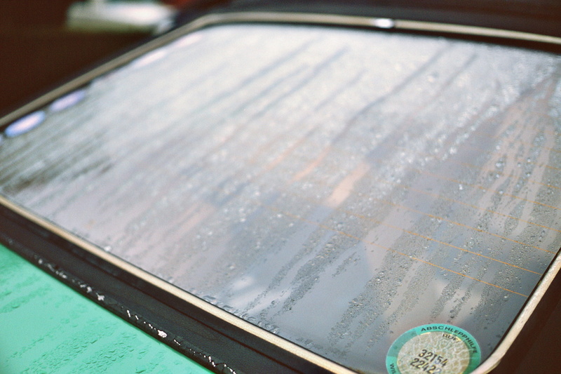 rear window, analogue feeling, business, no people, wet, car, nature, focus on foreground, 2K, water, grain, mode of transportation, finance, analog, indoors