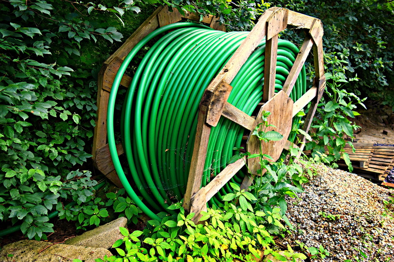 cable reel, no people, fuel and power generation, metal, container, leaf, water, cable, equipment, green color, plant, growth, drum reel, tool, wood - material