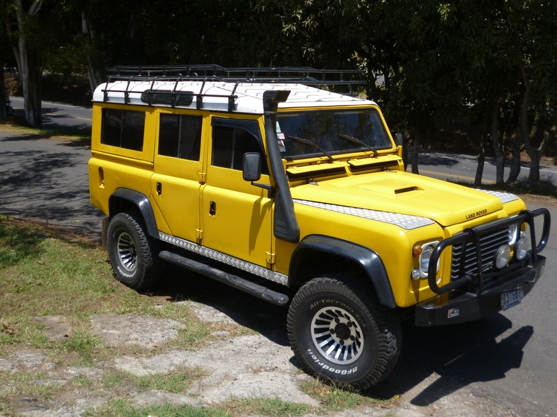 vehicle, city, plant, car, stationary, big, motor vehicle, sunlight, nature, outdoors, day, road, tree, retro styled, taxi, defender, mode of transportation