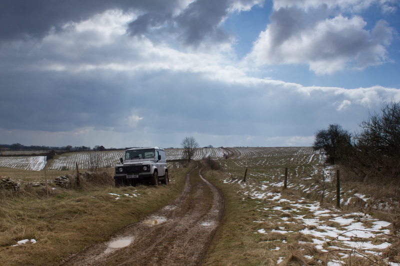 mud, sports utility vehicle, non-urban scene, land, landscape, motor vehicle, plant, sky, landrover, nature, direction, cloud - sky, track, outdoors, environment