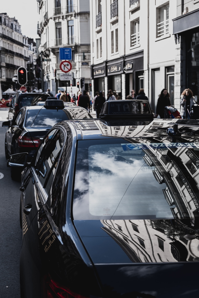 roof rack, car, clothing, building, mode of transportation, building exterior, metropolis, town, people, city, downtown, land vehicle, built structure