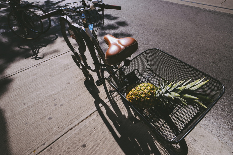 transportation, roof rack, land vehicle, road, high angle view, bicycle, one person, plant, freshness, bike, wheel, flowering plant, street, pineapple