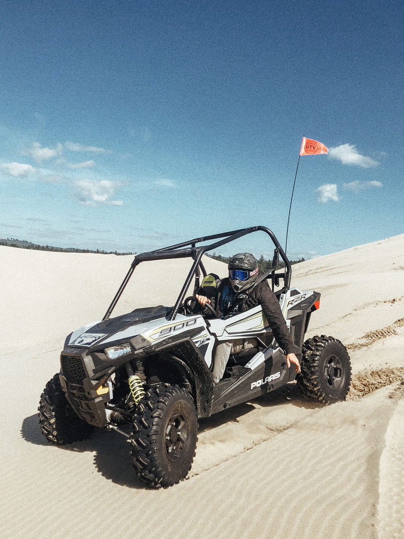 men, sunlight, sea, flag, outdoors, transportation, mode of transportation, person, riding, desert, sand, beach, blue, real people, cloud - sky, dune, land