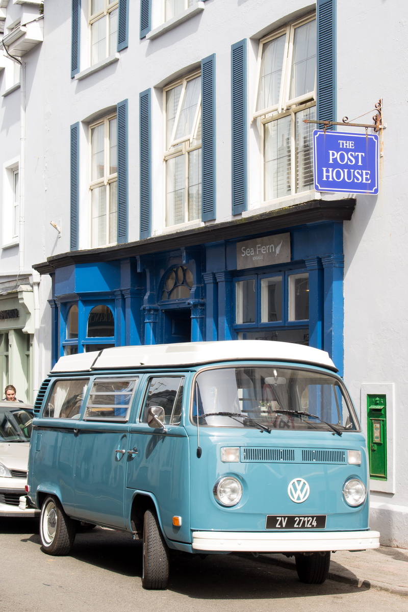 kinsale, human, automobile, day, building, van, architecture, person, road, land vehicle, communication, caravan, information sign, blue, city, minibus