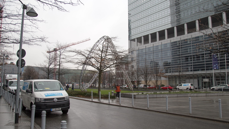 day, town, office building exterior, architecture, motor vehicle, vehicle, urban, built structure, building, automobile, plant, minibus, street, sky, rain