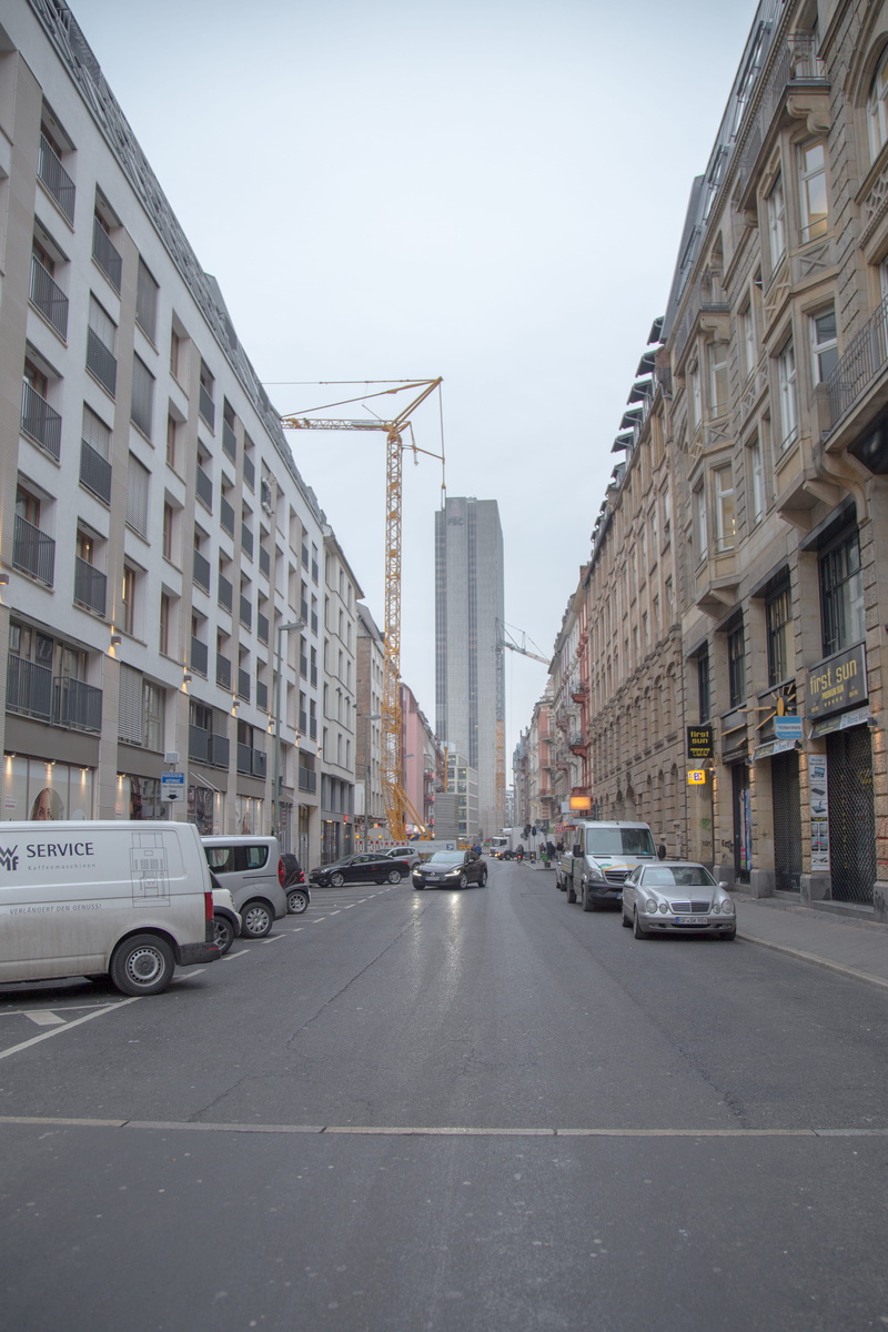 skyscraper, intersection, bus, residential district, mode of transportation, city, city street, motor vehicle, outdoors, land vehicle, building, building exterior
