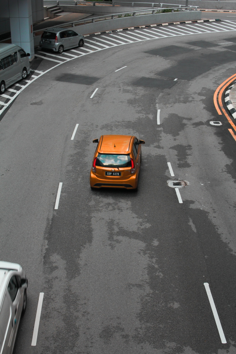 race car, high angle view, symbol, highway, van, coupe, transportation, moving van, car cars, wheel, tarmac, vehicle, on the move, automobile, sports car
