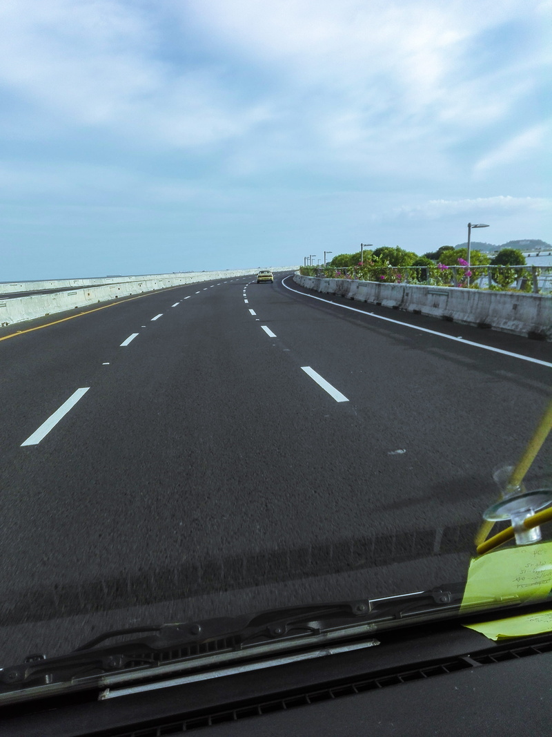 highway, transparent, sign, day, no people, wheel, zebra crossing, sky, windshield, automobile, marking, motor vehicle, road, symbol, gauge, dividing line