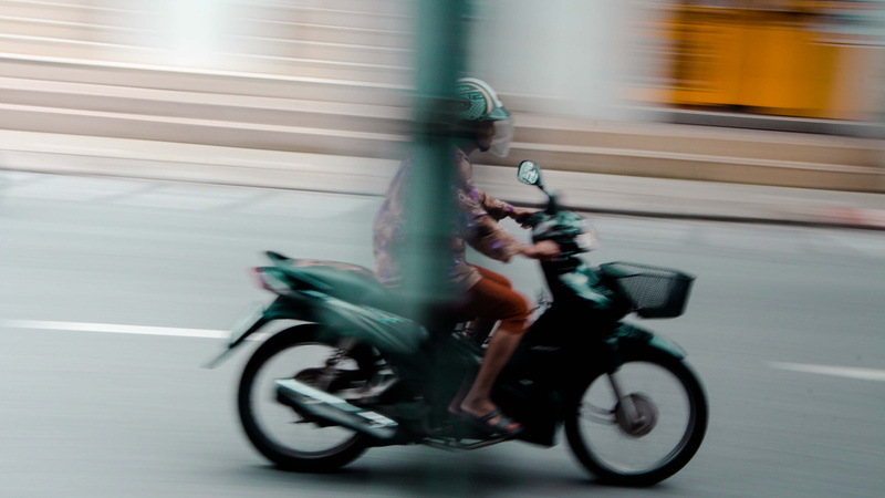 black, crash helmet, street, transportation, apparel, tire, spoke, vehicle, mode of transportation, road, motor scooter, machine, motion, on the move, ride