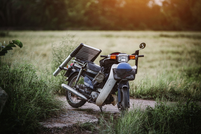 vehicle, field, transportation, near, underbone, ride, sky, nature, green, transportation system, pathway, mode of transportation, grass, focus on foreground