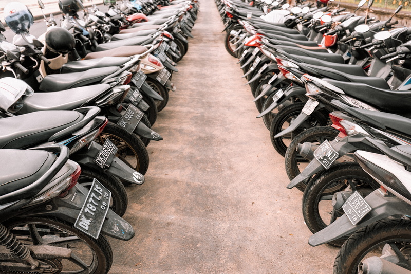 motorcycle, bike aisle, tire, side by side, abundance, consumerism, repetition, in a row, parking, underbone, business, land vehicle, area, motorbike lot