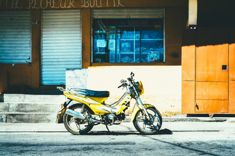 motorbike, window, underbone, mpoed, urban Scene, shadow, building, motorcycle, wall - building feature, wall, land vehicle, yellow, stationary, built structure