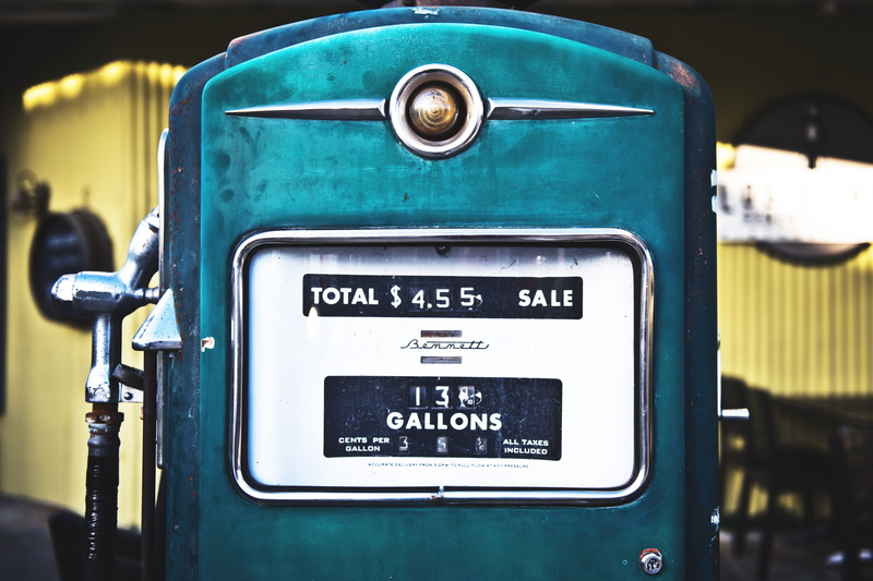 automobile, number, outdoors, transportation, information, gas pump, western script, focus on foreground, day, yellow, petrol, sign, colourful, text, gas