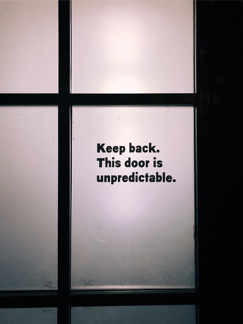 sign, no people, transparent, geometric shape, dark, black color, decals, communication, close-up, shape, overlay, indoors, window, day, pattern, humor
