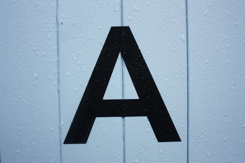 black, decor, warning sign, road, white color, shape, wall - building feature, sign, day, letter, triangle shape, information sign, symbol, wet, safety