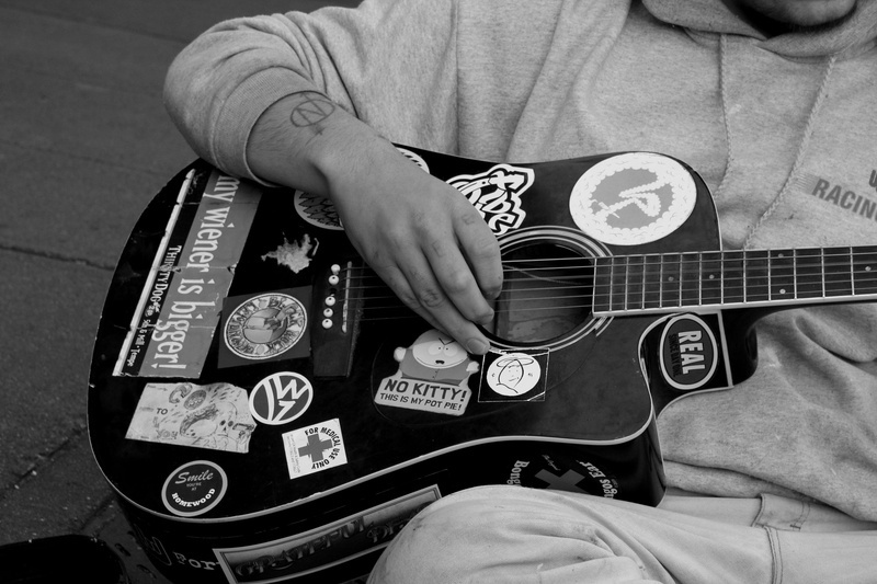 decals, midsection, leisure activity, high angle view, lifestyles, one person, holding, communication, human hand, strum, hand, decal, musical instrument