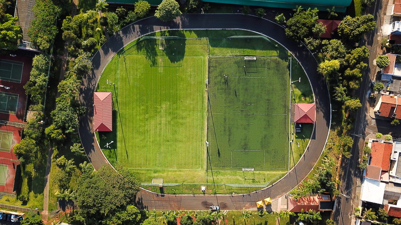 campus, team sport, outdoors, no people, arena, building, tranquility, day, sunlight, field, plant, football field, daytime, park, 2K, grass, green, angle