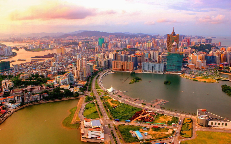 skyscraper, travel destinations, cloud - sky, building exterior, water, cityscape, macau, city, building, built structure, no people, bridge, aerial view