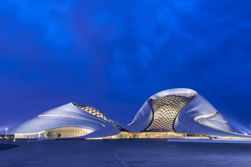 china, convention center, triangle shape, no people, night, building exterior, sky, travel destinations, outdoors, harbin, blue, built structure, illuminated