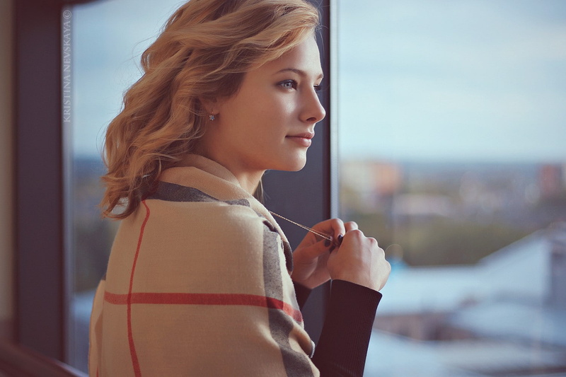 Kristina Nevskaya, women, blonde, curly hair, looking out window, 720P, portrait, window, smiling