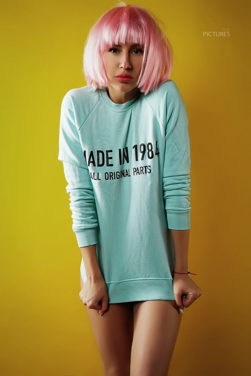 yellow background, blond hair, text, one person, pink hair, studio shot, fashion, women, YFUNNY, three quarter length, hairstyle, western script, females