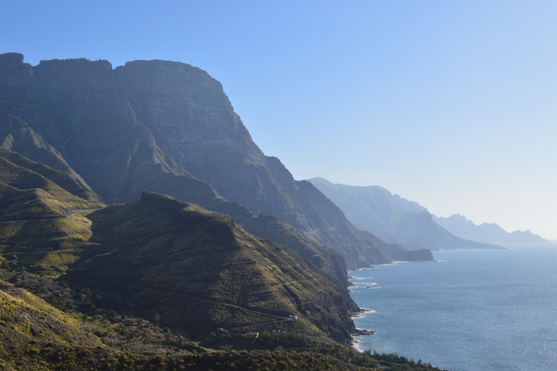 no people, beach, travel destinations, bay, sea, cliff, clear sky, mountain, beauty in nature, gran canaria, water, rock, sky, tranquil scene, tranquility