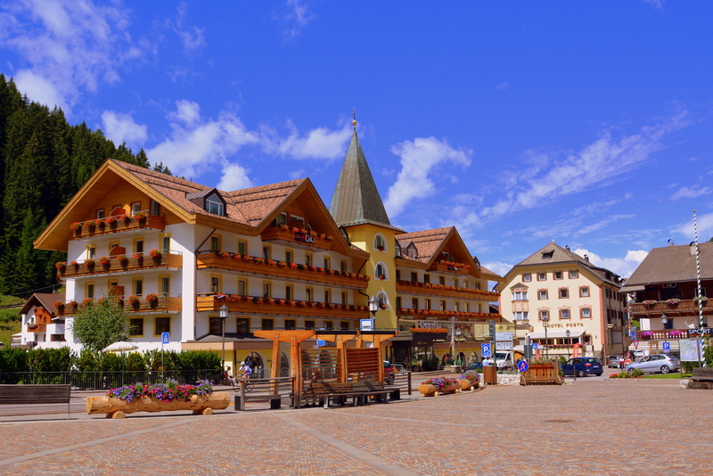 block, built structure, city, sky, plant, outdoors, town, cloud - sky, incidental people, residential district, building, mountain, italy, valgardena, center