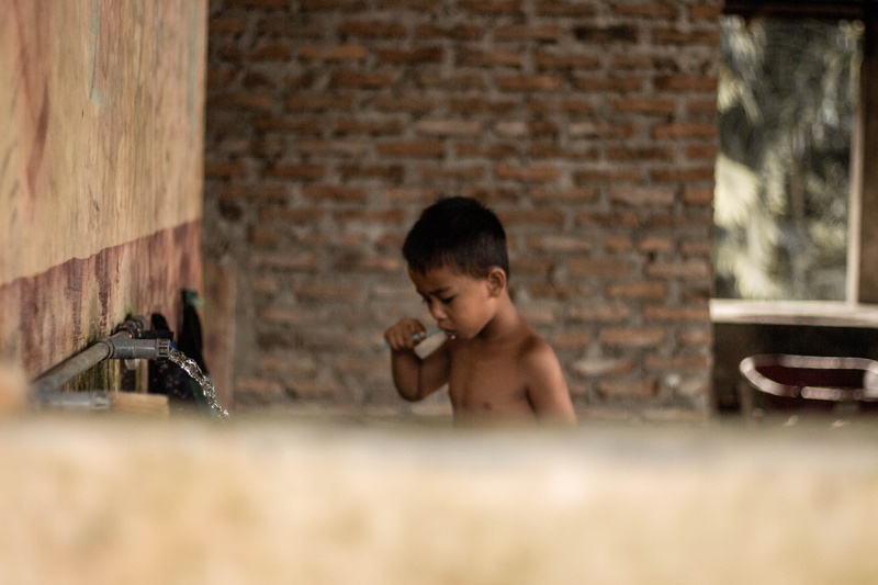 brick wall, namu keeling, domestic room, child, innocence, village, portrait, 5K, indoors, shirtless, emotion, brown hair, brick, headshot, males, indonesia
