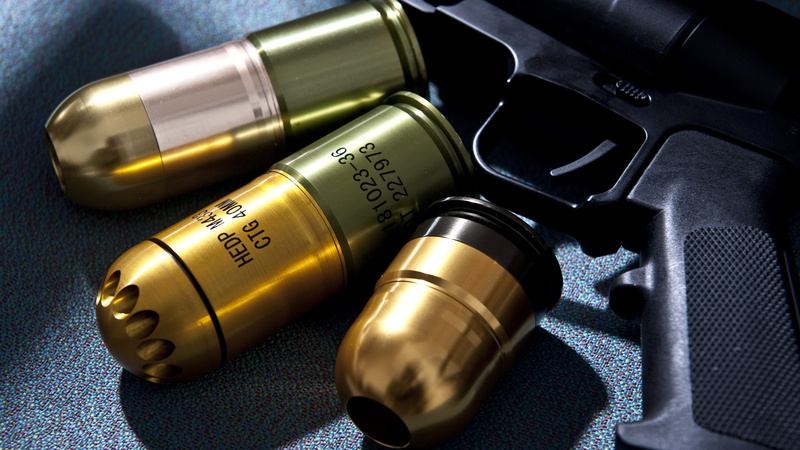indoors, text, close-up, grenade launchers, still life, studio shot, communication, technology, no people, 5K, ammunition, 40MM Grenade, music, equipment