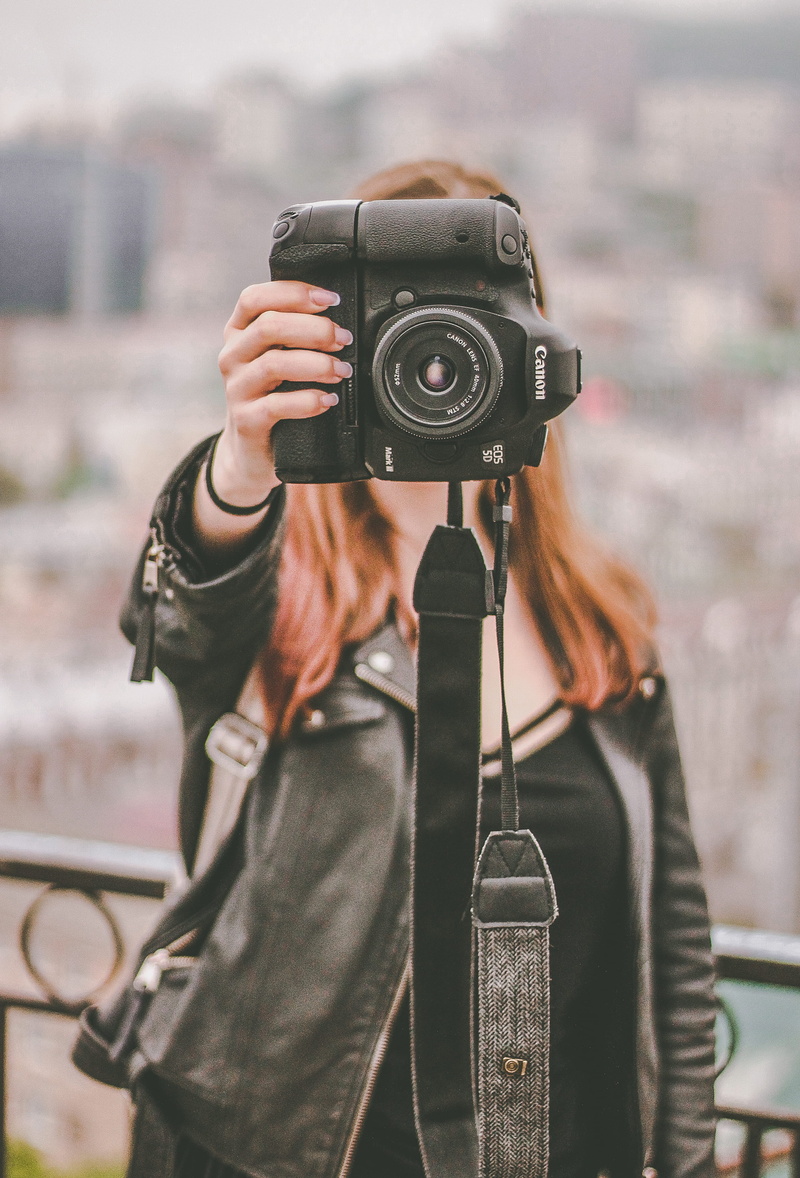outdoors, standing, lifestyles, digital camera, camera - photographic equipment, focus on foreground, beside, model, front view, fence, 40mm f/2.8, photographer