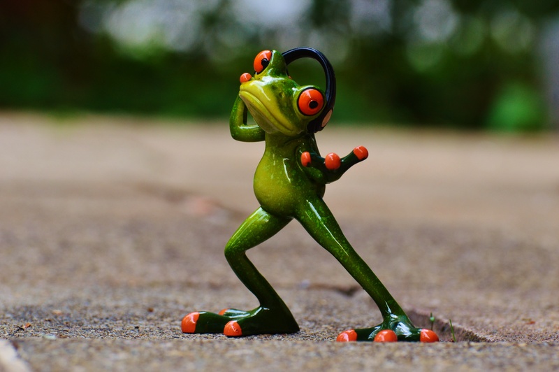 figurine, headset, female likeness, nature, green, representation, fun, craft, day, funny, wearing, focus on foreground, no people, creativity, human representation