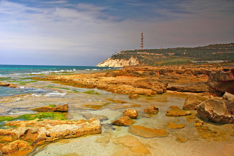 cavern, building exterior, nature, coast, rosh, cloud - sky, rocky coastline, sea, guidance, water, no people, solid, horizon over water, lighthouse, outdoors