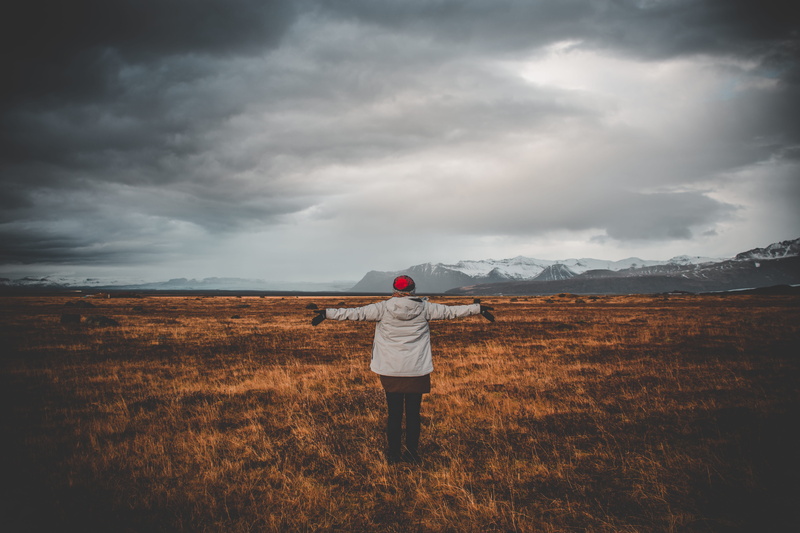 one person, beauty in nature, countryside, skaftafell, land, rear view, iceland, grassland, nature, standing, plateau, leisure activity, real people, hat