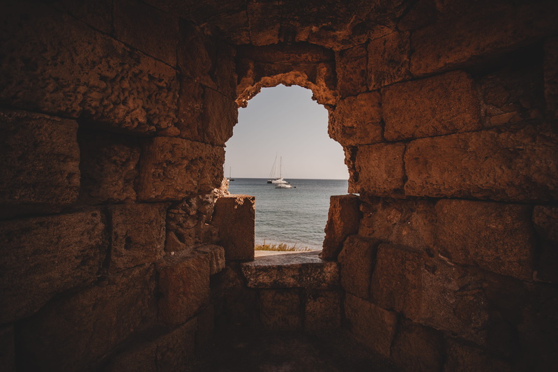 rock - Object, stone Material, famous Place, sun, travel Destinations, water, horizon, architecture, summer, hole, seascape, sail, white, cave, fort, boat