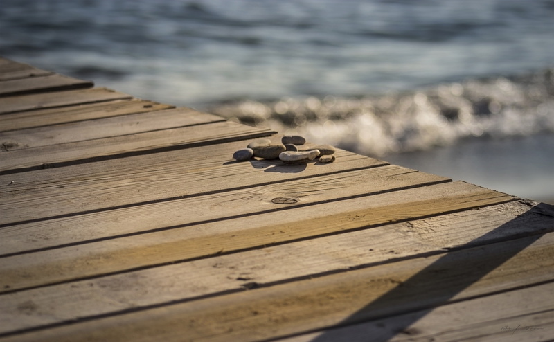 sunlight, beauty in nature, gray, selective focus, motion, pebbles, motorcycle, day, beach, sea, pier, jetty, outdoors, 5K, nature, water, no people, wood