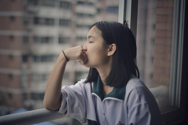 white, window, youth, long hair, metal, focus on foreground, leaning, one woman only, young Women, black hair, female, only women, looking out, teenager