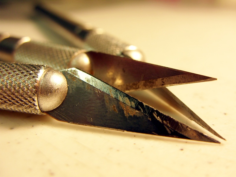 high angle view, no people, slice, crafting, object, single object, work, indoors, paper, edge, steel, blade, carving, cut, scalpel, man made object, metallic